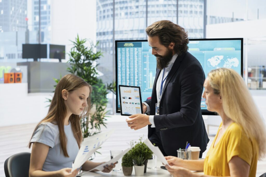 Financial advisor guiding mother and daughter in trading shares