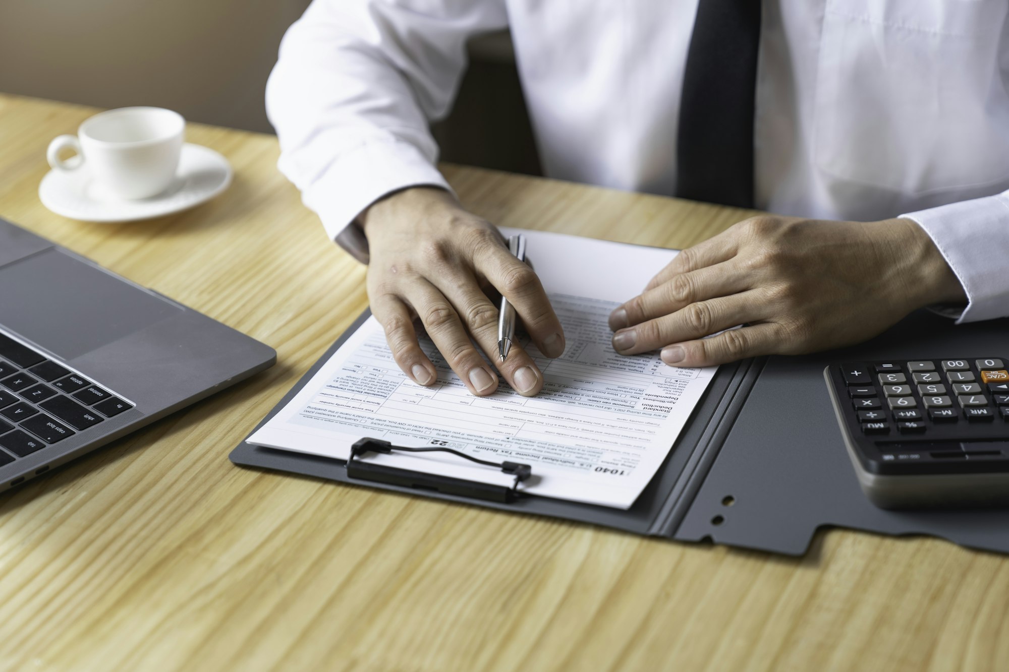 Individual Tax Return Forms on the table, An accountant working with US tax forms, Accountant calcul