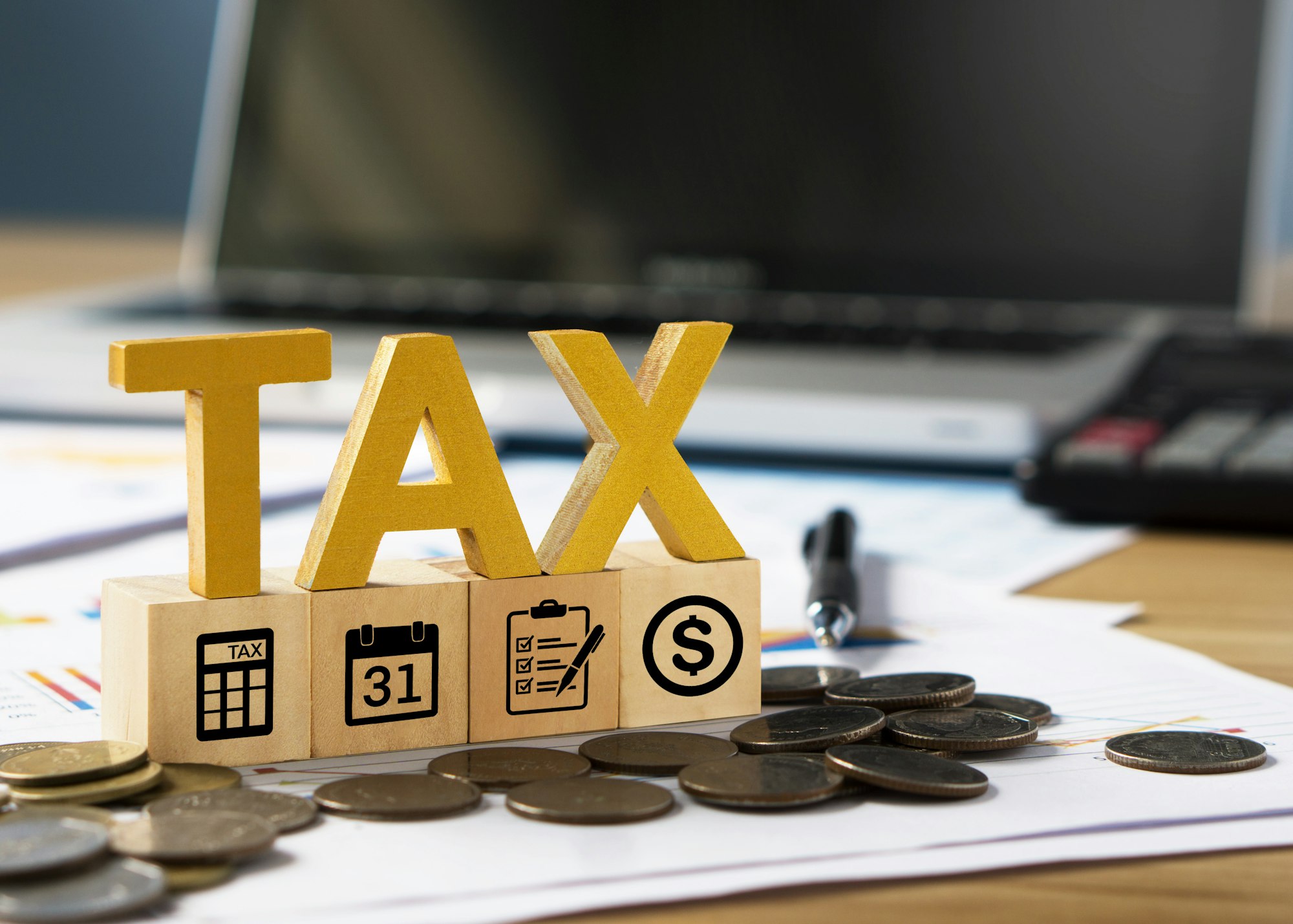 Tax wooden letter and tax icon on wooden block.Pay tax in new year.