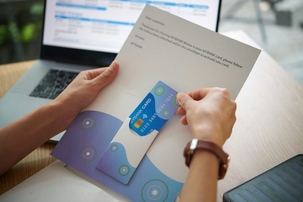 Woman Opening Bank Letter with Card